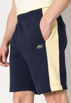 Lacoste Unisex - Trainingsbroek - Marine/Jaune -Lacoste 293b15d9a58c4160beb794ecd0ca414a scaled